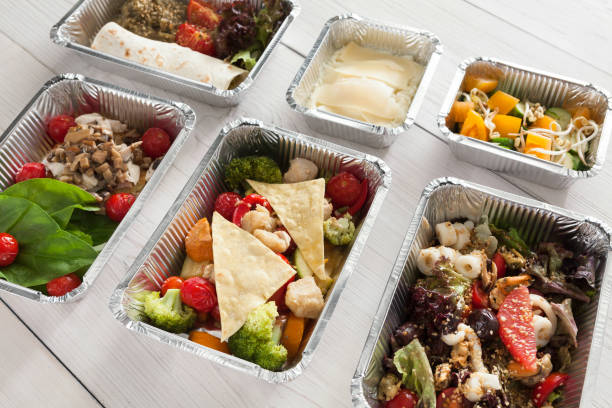 Healthy food background. Take away meals in foil boxes. Fitness...