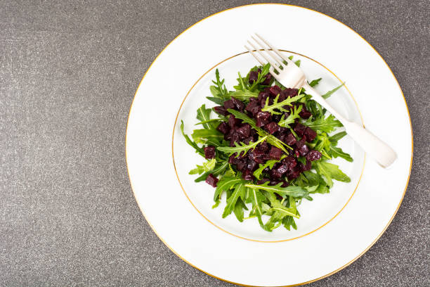 Healthy food-dishes from beets and arugula. Studio Photo