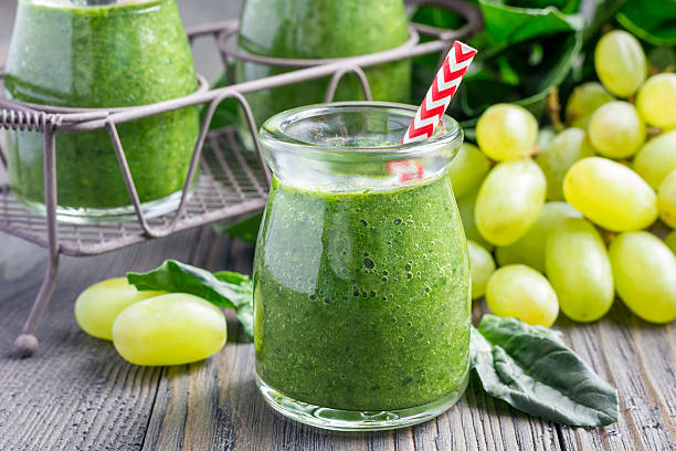 Healthy green smoothie with spinach, grape and banana stock photo