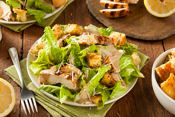 Healthy Grilled Chicken Caesar Salad Healthy Grilled Chicken Caesar Salad with Cheese and Croutons chicken salad stock pictures, royalty-free photos & images