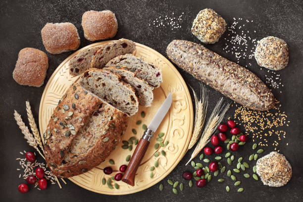 Healthy High Fibre Rye Bread and Seeded Rolls High fibre cranberry & pumpkin seed rye bread with wholemeal & seeded rolls. High in vitamins, antioxidants & omega 3 with low gi. Health food to reduce high blood pressure, cholesterol & optimise a healthy heart. 7 grain bread photos stock pictures, royalty-free photos & images