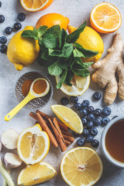 healthy ingredients for boosting immunity and anti-flu. citrus fruits, ginger, turmeric,  honey, blueberries and mint on a white background, health concept. - alimentos sistema imunitário imagens e fotografias de stock