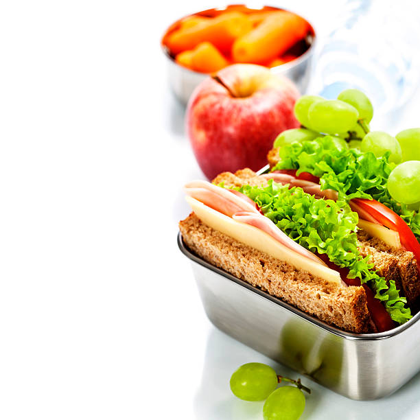 Healthy lunch Lunch box with sandwich, fruits and water on white background 7 grain bread photos stock pictures, royalty-free photos & images