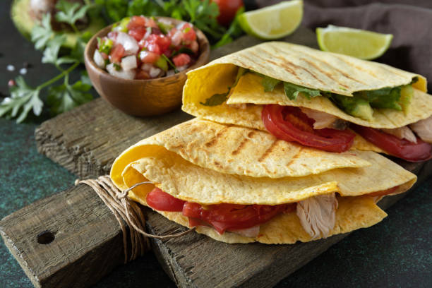 Healthy lunch. Tortilla sandwich, mexican wraps  with grilled chicken fillet and avocado, served with guacamole. stock photo
