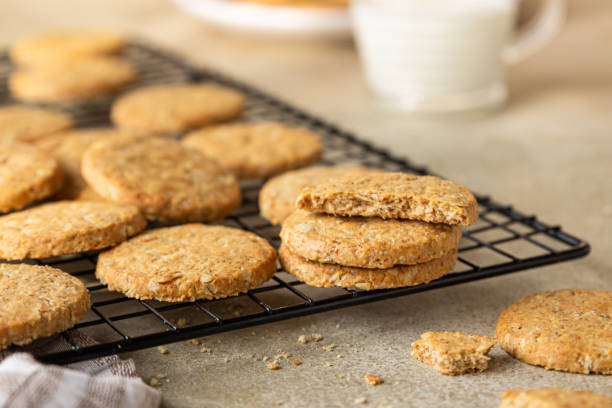 Healthy oatmeal cookies with cereals, seeds and nuts with a cup of milk on concrete background. Diet vegan cookies. stock photo
