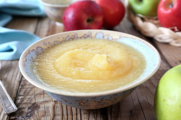 Healthy organic apple sauce in ceramic bowl stock photo
