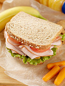 Healthy Packed Lunch with a Ham, lettuce, Tomato and cheese Sandwich with Fresh fruit, Orange Juice, Baby Carrots and Cookies -Photographed on Hasselblad H3D2-39mb Camera