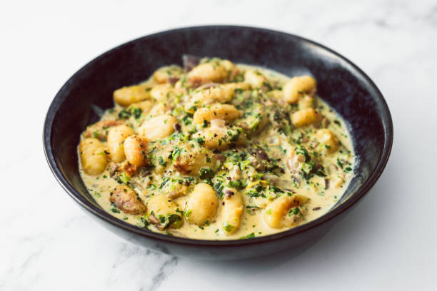 healthy plant-based food, vegan cheese and spinach potato gnocchi stock photo