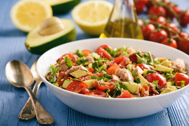 Healthy salad with tuna,cherry tomatoes and avocado. stock photo