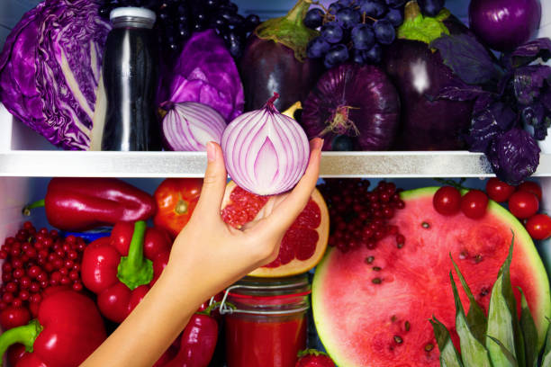 Healthy summer raw fruits and vegetables in vegan vegetarian fridge stock photo