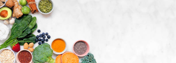 Healthy super food ingredients. Top view corner border on a white marble banner background. Copy space. stock photo