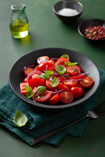 healthy tomato salad with onion basil olive oil and balsamic vinegar stock photo