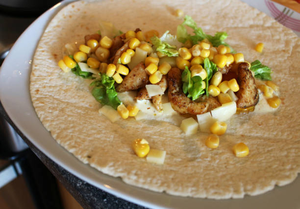 Healthy tortilla with meat, salad, cheese and corn stock photo