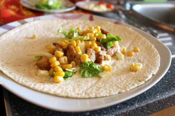 Healthy tortilla with meat, salad, cheese and corn stock photo
