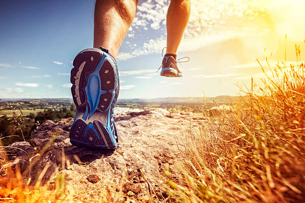 Healthy trail running Outdoor cross-country running in summer sunshine concept for exercising, fitness and healthy lifestyle running stock pictures, royalty-free photos & images