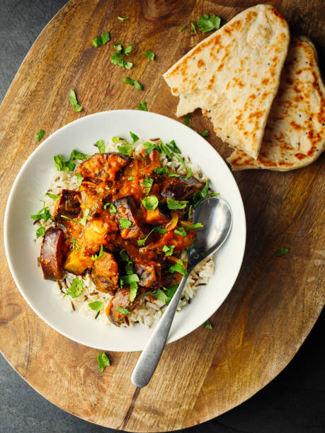 Healthy Vegan aubergine masala with long grain rice and naan bread Home made freshness vegan aubergine masala on top of long grain and wild rice service with naan bread curry meal stock pictures, royalty-free photos & images