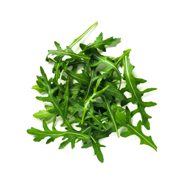Heap of arugula leaves isolated Heap of arugula leaves. Fresh green arugula or rucola leaves isolated on white with clipping path. Top view or flat lay arugula stock pictures, royalty-free photos & images