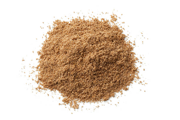 Heap of coriander powder Heap of coriander powder on white background coriander seed stock pictures, royalty-free photos & images