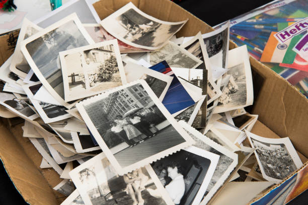 Heap of Nostalgic Vintage 20th Century Memories in Photographs "New York City, United States - July 21, 2012: A cardboard box full of vintage black and white photographs sits on display for sale in the Williamsburg neighborhood of Brooklyn." full photos stock pictures, royalty-free photos & images
