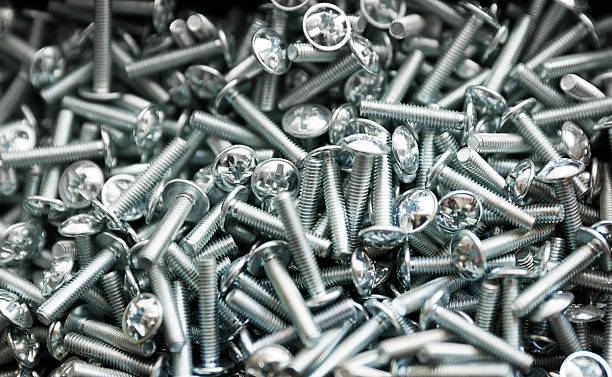 Heap of short metal bolts stock photo