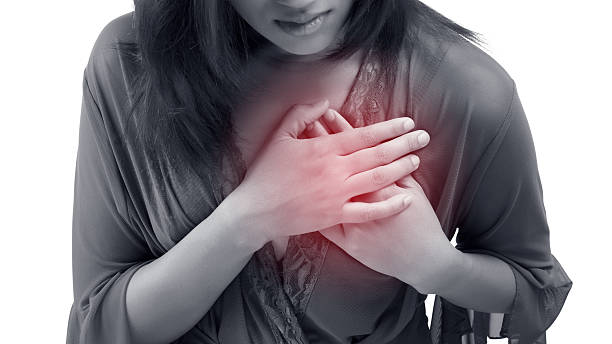 Heart attack Woman is clutching her chest, acute pain possible heart attack acute angle stock pictures, royalty-free photos & images