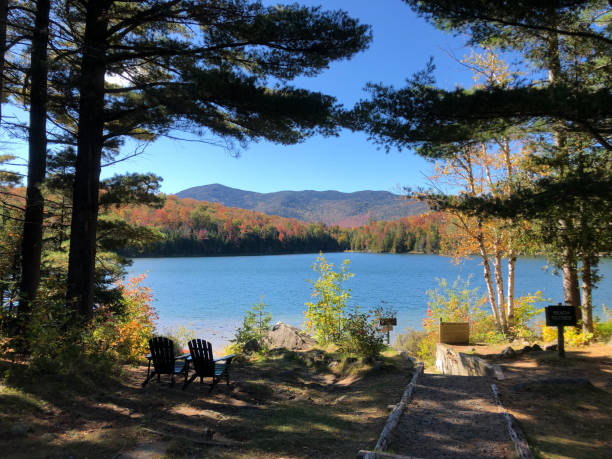 Heart Lake, Adirondack Park, New York Adirondacks, New York, USA 09/27/2019: Sunny view of Heart Lake and surrounding mountains in Adirondack Park, New York. adirondack state park stock pictures, royalty-free photos & images