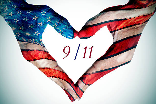 heart patterned as the flag of the United States the text 9/11 written in the blank space of a heart sign made with the hands of a young woman patterned as the flag of the United States 911 remembrance stock pictures, royalty-free photos & images