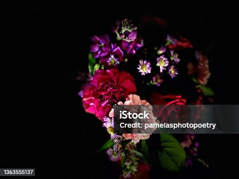 istock Heart shaped bouquet of flowers isolated against black background - stock photo 1363555137