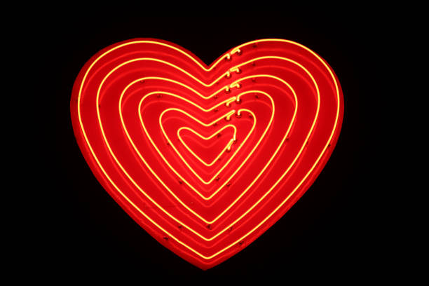 Heart Shaped Sign Illuminated Heart Shaped Sign at night overland park stock pictures, royalty-free photos & images
