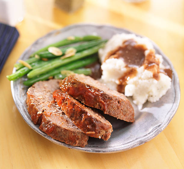 hearty meatloaf dinner with sides - meat loaf stok fotoğraflar ve resimler