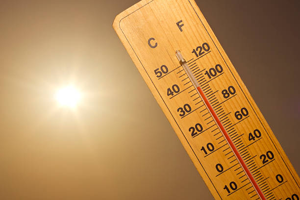 heat wave thermometer with a 100 degrees Fahrenheit (38 degrees Celsius) and the Sun in the back. fahrenheit stock pictures, royalty-free photos & images