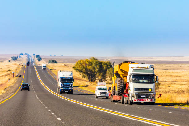 Heavy Cargo on the Road transporting construction machinery stock photo