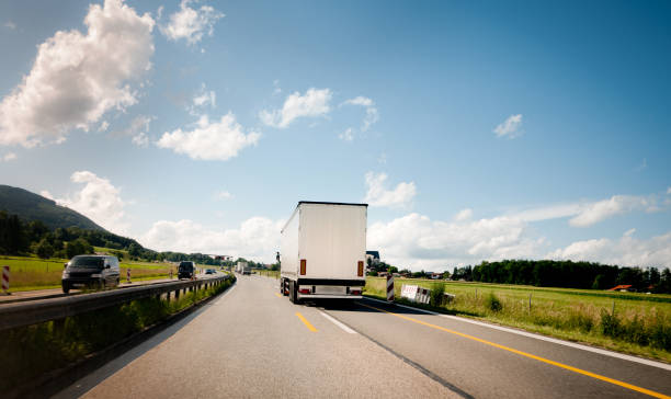 Heavy Cargo transportation on Highway Heavy Cargo transportation on Highway semi truck back stock pictures, royalty-free photos & images