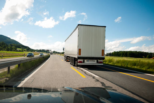 Heavy Cargo Truck on a Highway - stock Photo Heavy Cargo Truck on a Highway - stock Photo semi truck back stock pictures, royalty-free photos & images