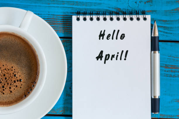 Hello April on Notebook at blue rustic table with morning coffee cup. Top view Hello April on Notebook at blue rustic table with morning coffee cup. Top view. march calendar 2017 stock pictures, royalty-free photos & images