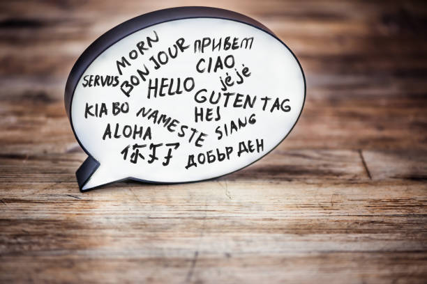 Hello in many languages Lightbox in form of a Speech bubble on wood desk showing the word Hello in many languages. linguistics stock pictures, royalty-free photos & images
