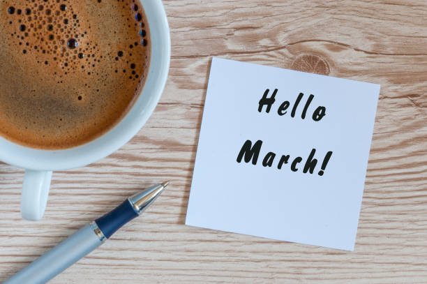 Hello MARCH - note at wooden office table with pen and mug of morning coffee. Spring concept Hello MARCH - note at wooden office table with pen and mug of morning coffee. Spring concept. march calendar 2017 stock pictures, royalty-free photos & images