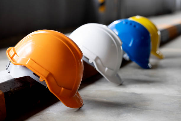 Helmets for construction workers, engineers, technicians, inspectors who work on construction sites. Safety hardhat while working to prevent accidents. work equipment of Blue collar stock photo