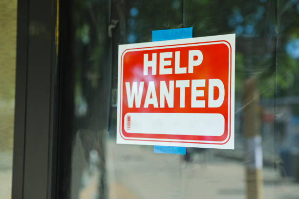 Help wanted sign in front of store front stock photo
