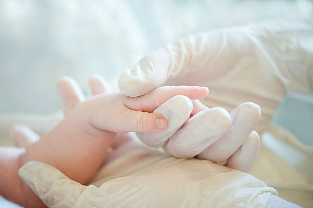 Helping hand to little baby stock photo
