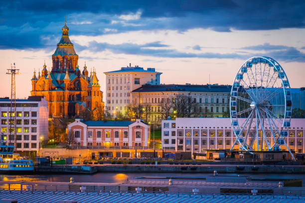Helsinki Uspenski Cathedral and harbour waterfront ferris wheel illuminated Finland stock photo
