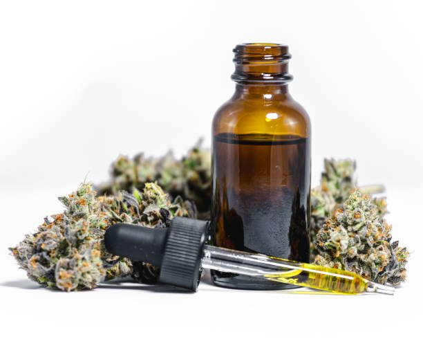 CBD Hemp Oil with Marijuana Buds on White Background stock photo