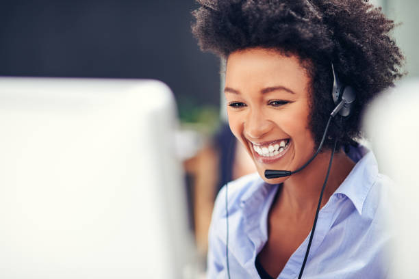 Her voice puts customers at ease Shot of an attractive young woman working in a modern call centre headset woman customer service stock pictures, royalty-free photos & images