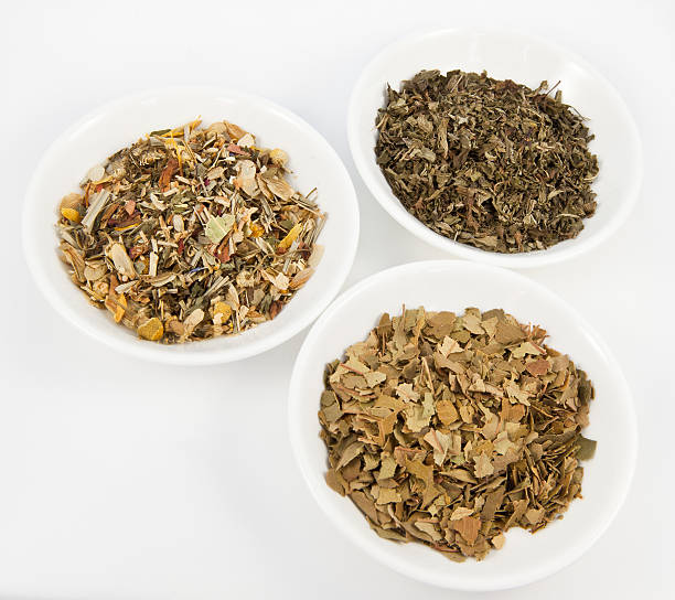 Herbal teas in small white bowls stock photo