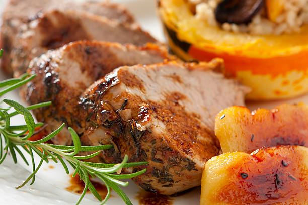 Herb-roasted  Loin of Pork with Apples stock photo