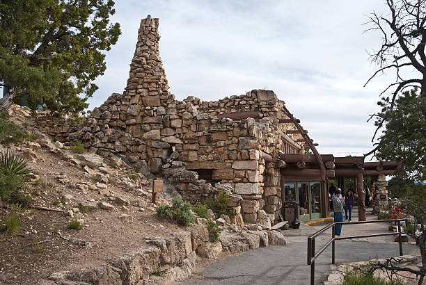 Visitors Mill About in Front of the Hermit's Rest Shelter Grand Canyon National Park, Arizona, USA - May 17, 2011: Hermit's Rest is one of the historic buildings designed by famed architect Mary Coulter. The stone structure was built in 1914. This group of visitors are milling about in front of the building. jeff goulden grand canyon national park stock pictures, royalty-free photos & images