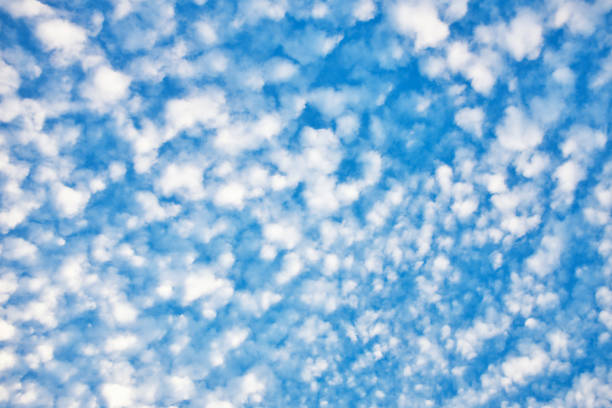 Herringbone pattern effect of cumulocirrus clouds in a summer sky Textured clouds high in the sky make an atmospheric background. altocumulus stock pictures, royalty-free photos & images