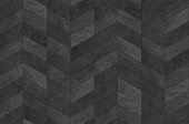 Parquetry flooring surface, chevron pattern texture.