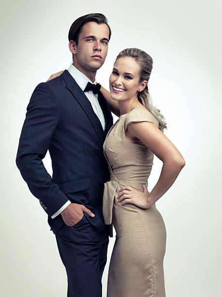 He's a hit with the ladies A studio portrait of a couple in stylish vintage evening wear cougar woman stock pictures, royalty-free photos & images