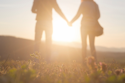 Defocused people. Togetherness. Photo is taken at beautiful sunset of springtime day in nature.